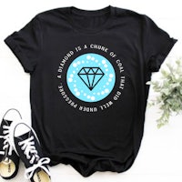a black t - shirt with a diamond on it and a pair of sneakers