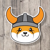 a sticker of a viking dog with horns