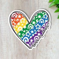a rainbow heart sticker with the words love is love