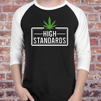 a man wearing a t - shirt that says high standards