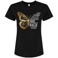 a gold butterfly on a black t - shirt